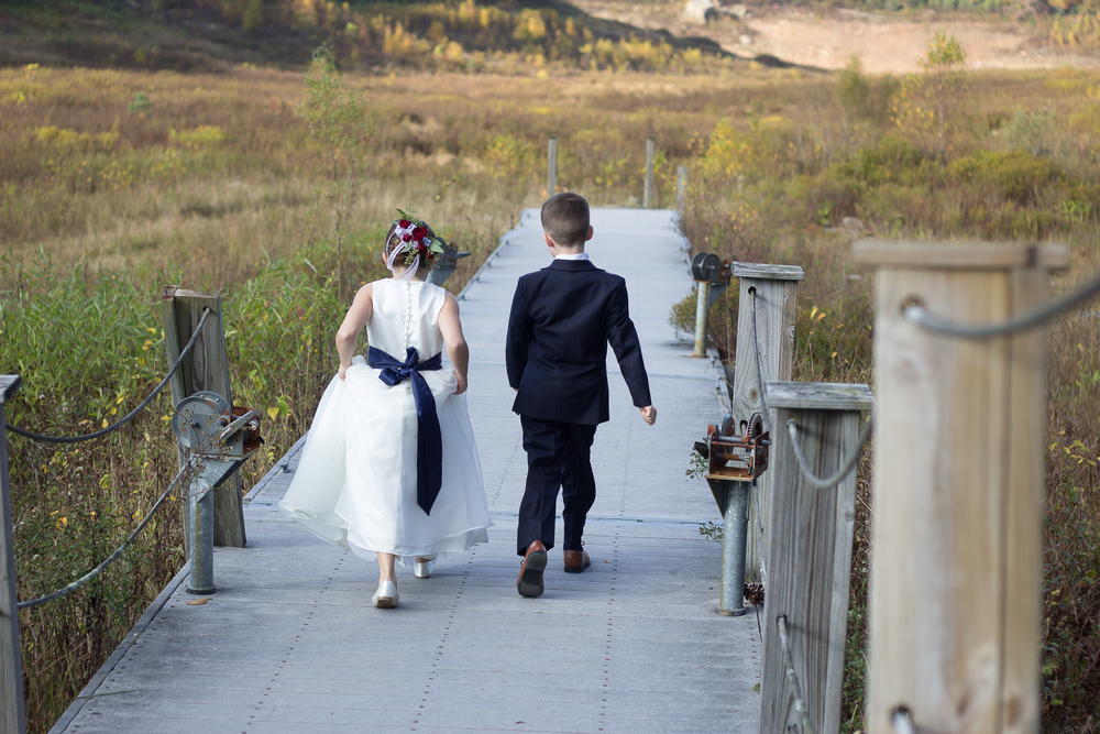 Flower Girl and Ring Bearer Walking down a dock