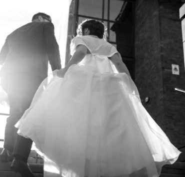 bride and groom walking on staircase