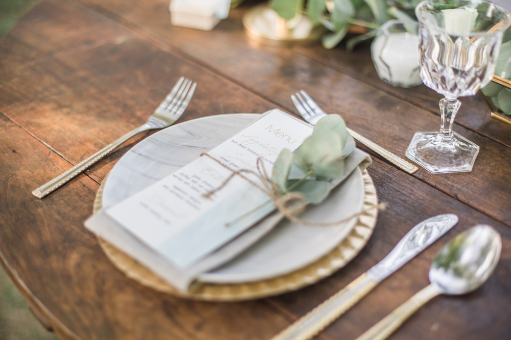 white small wedding menu card on top of white plate