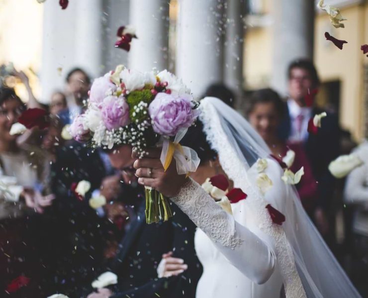 bride and groom showered with flowers