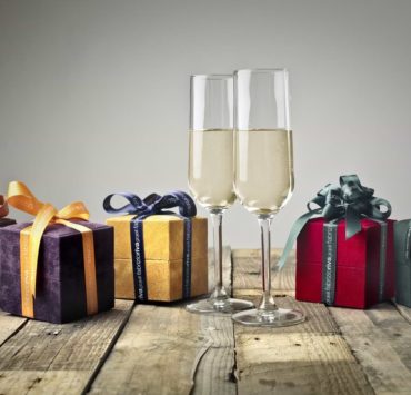 assorted presents and a glass of champagne