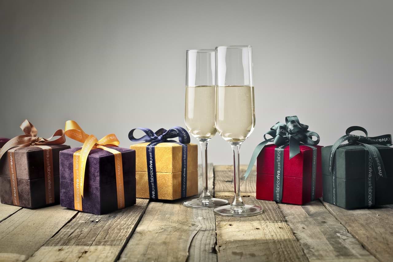 assorted presents and a glass of champagne