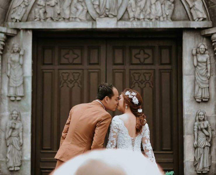 Filipino couple kiss outside church
