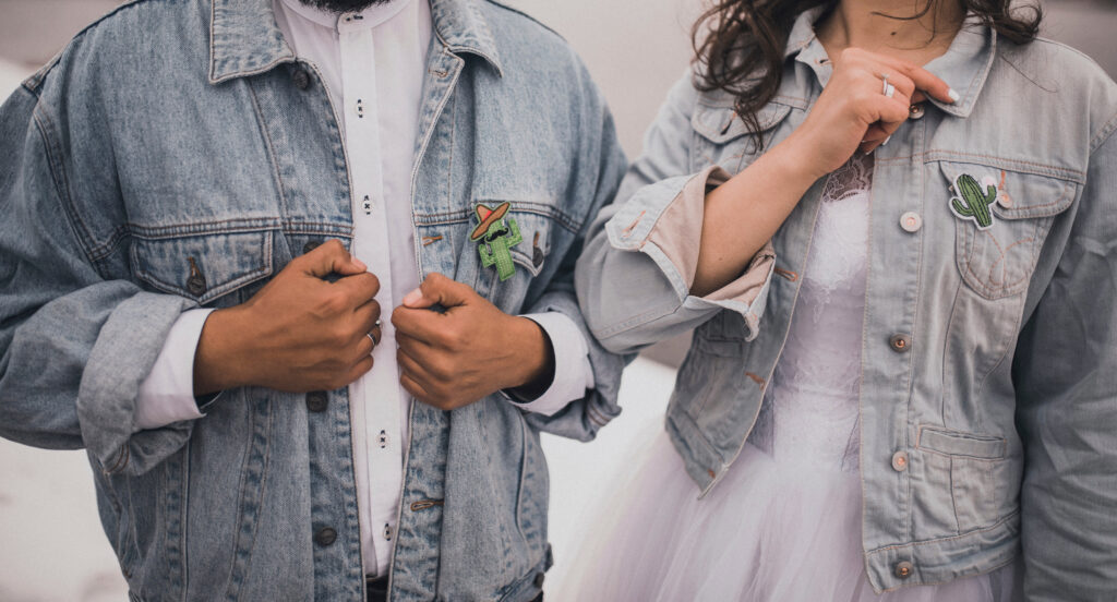 the bride and groom wearing denim jackets