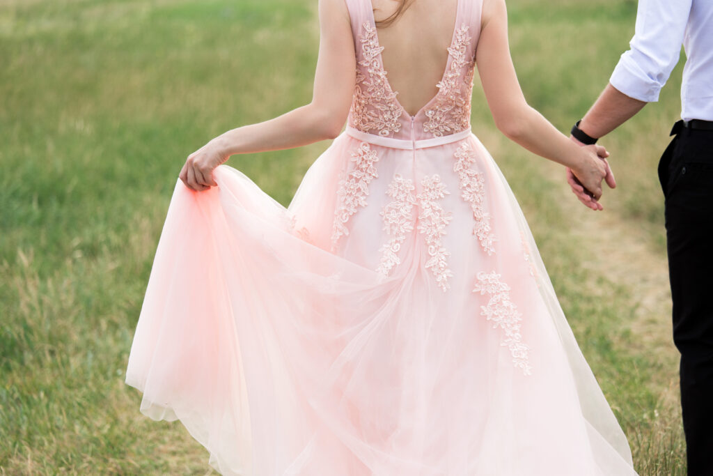 bride and groom walking on a hill