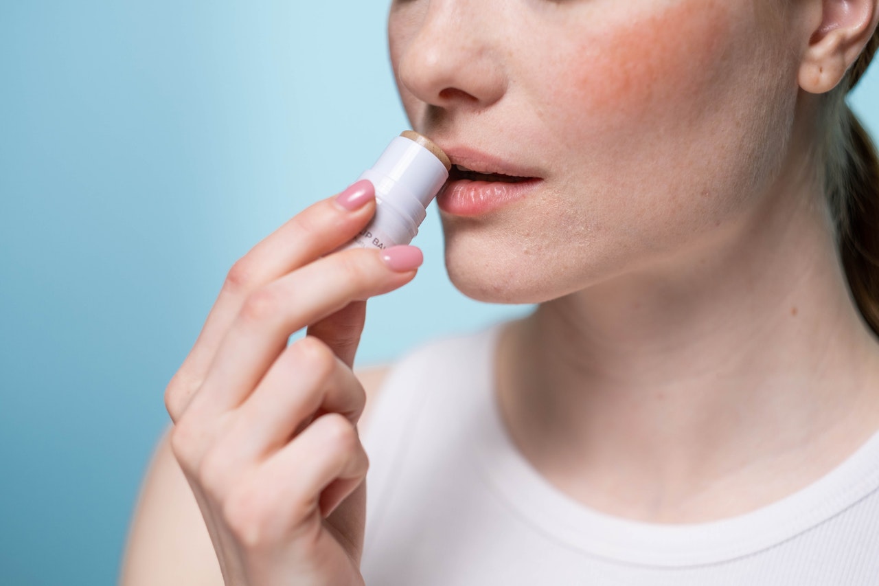 woman applying lip balm