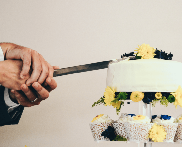 Couple cutting wedding cake