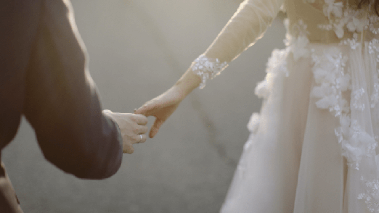 Wedding couple holding hands