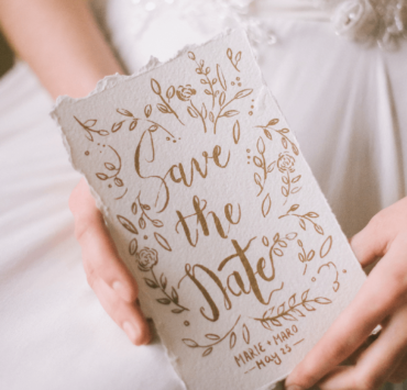 Bride holding a card with Save the Date written on it