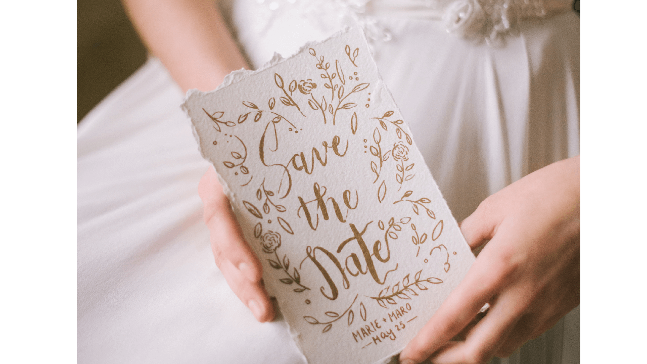 Bride holding a card with Save the Date written on it