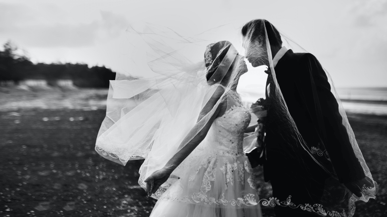 Couple under bride's veil