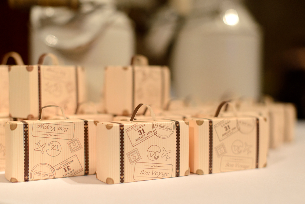 Travel themed cardboard suitcases at a wedding reception