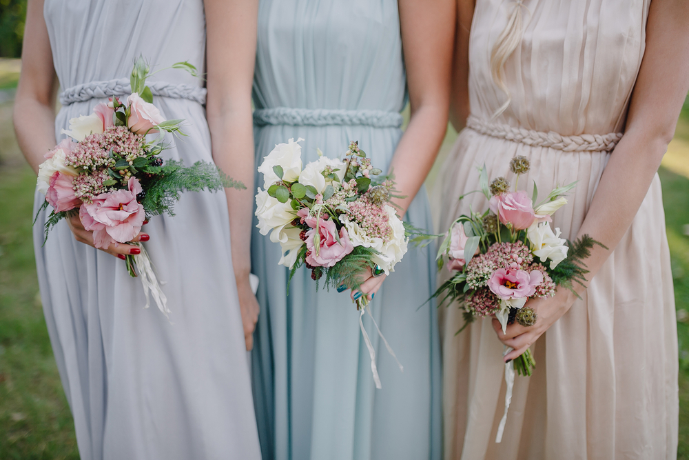 bridesmaids carrying rustic floral arrangements for a wedding