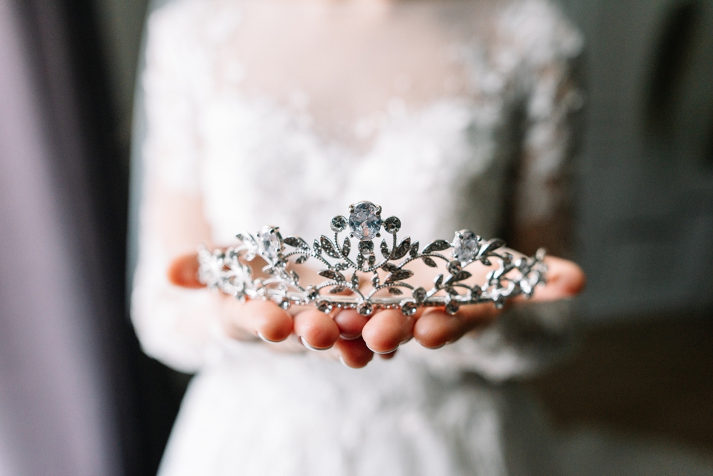 bride holding a crown (diadem) of stones on wedding day