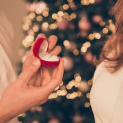 close up of man and woman during proposal on Christmas