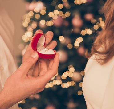 close up of man and woman during proposal on Christmas