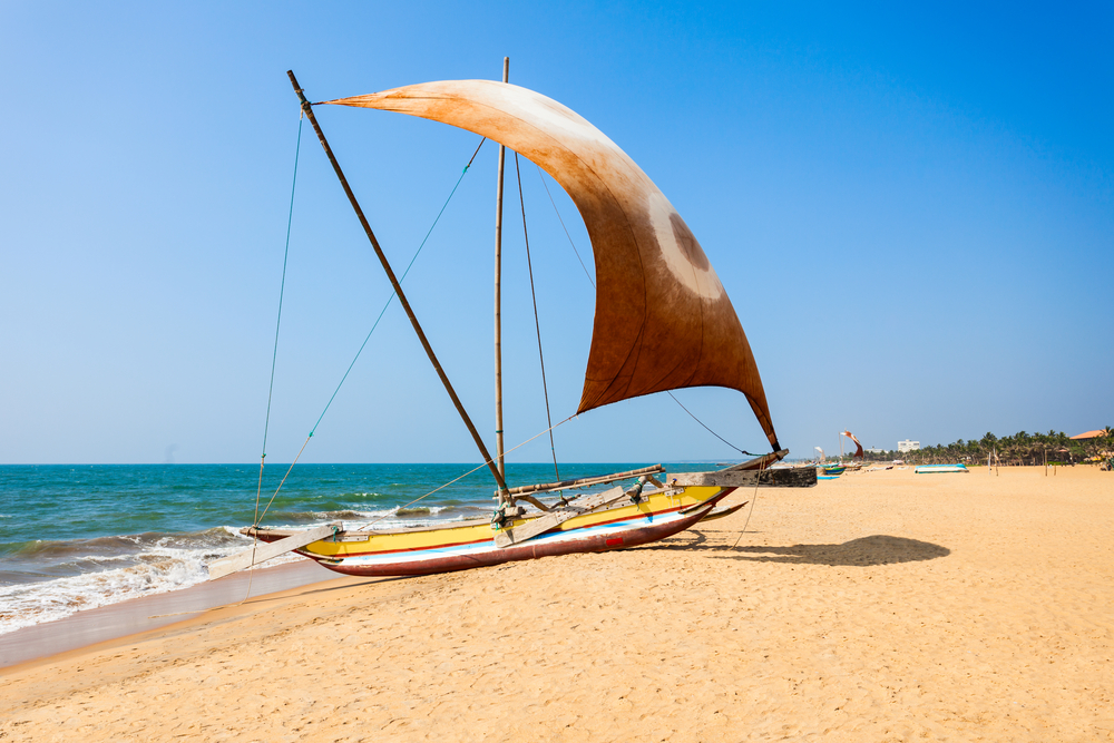 a boat on a beach in sri lanka