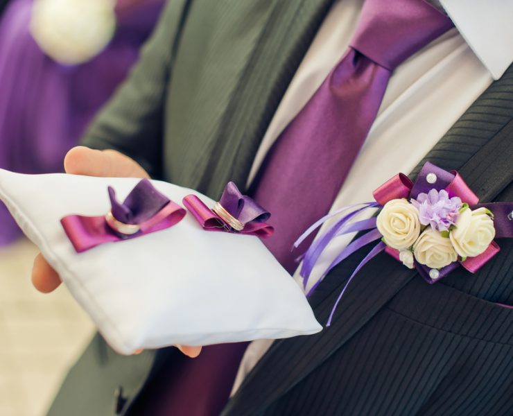 ring bearer holding the wedding ring pillow