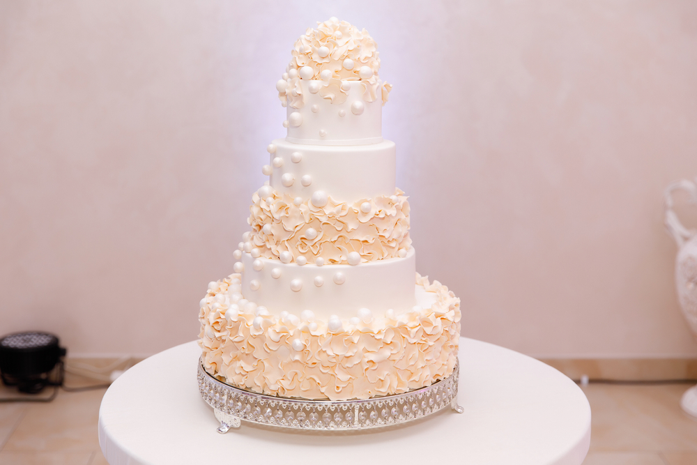 a five tier wedding cake with decorations