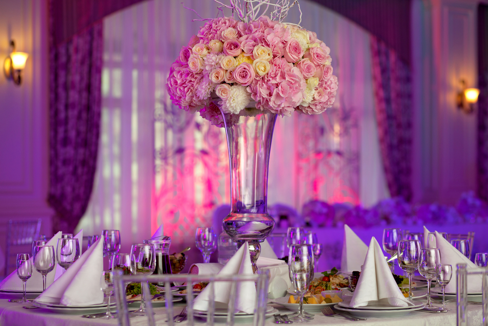 tall floral centerpiece in the middle of a round table
