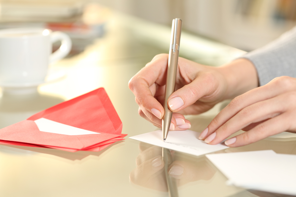 woman writes a card for vendors