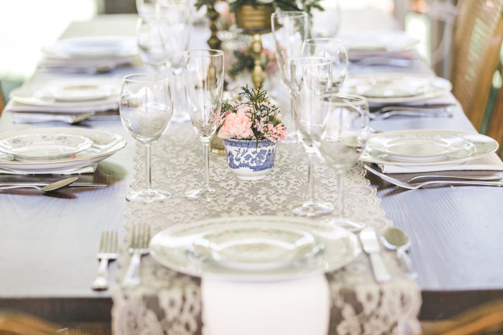 a wedding banquet table with a lace runner