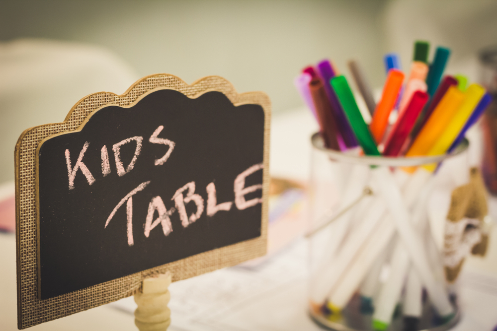 a coloring station for kids at a wedding reception