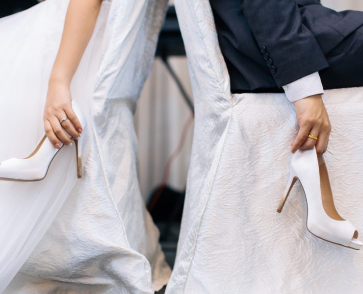 bride and groom playing the shoe game at a wedding reception