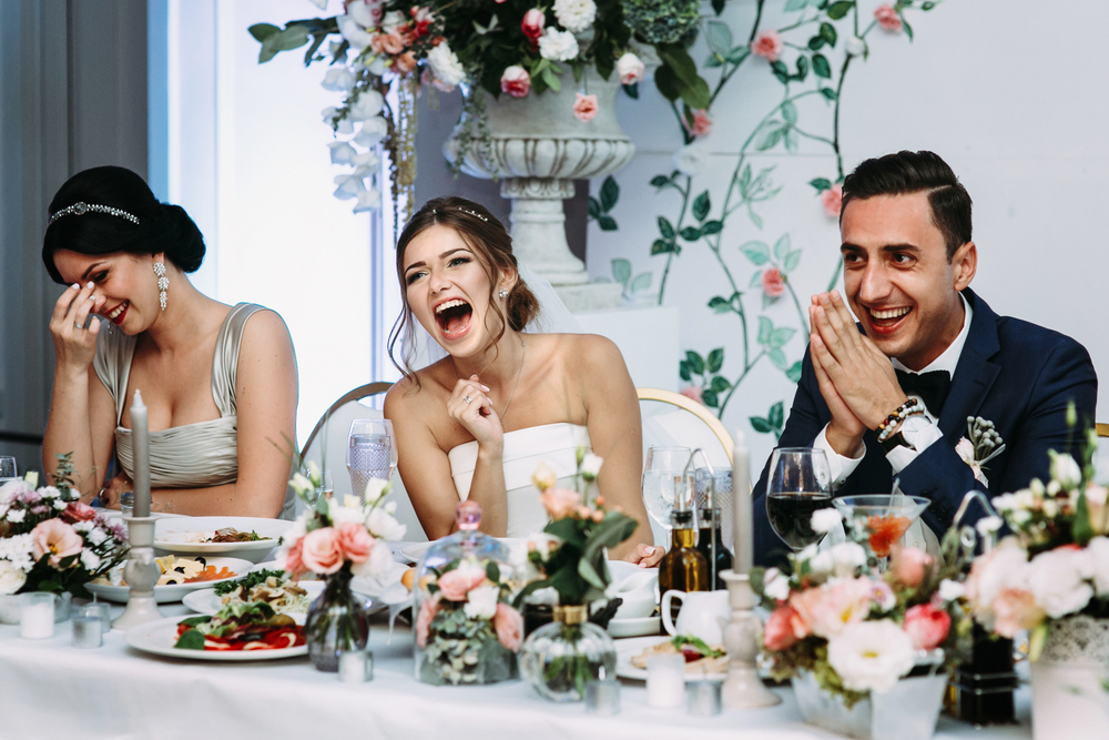 people laughing while playing games at a wedding