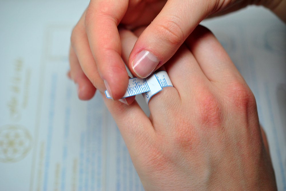 Girl measuring her ring size