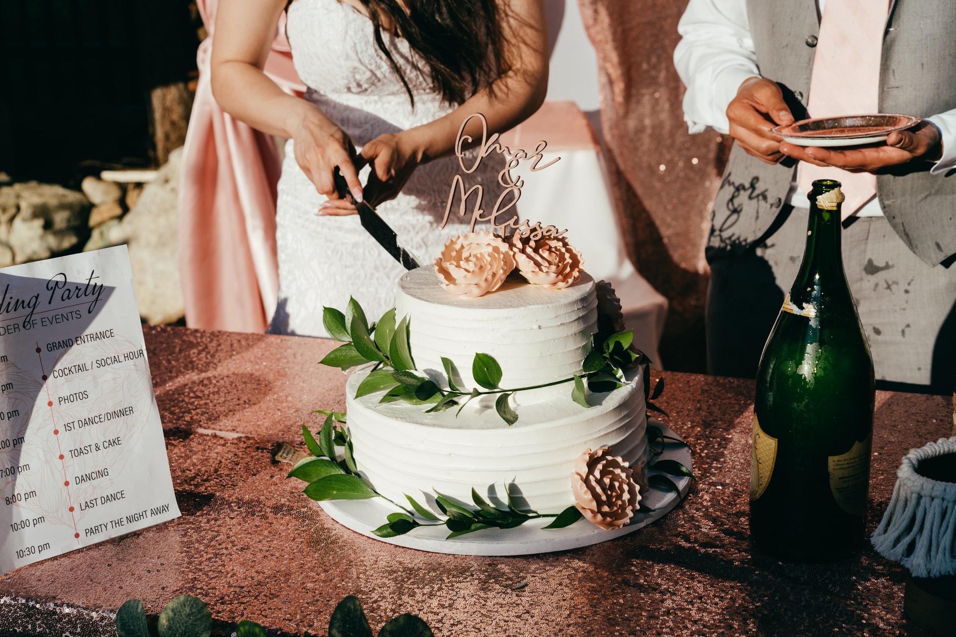 bride and groom slicing their wedding cake