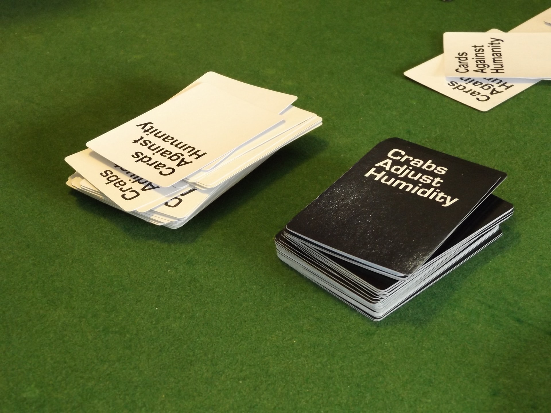 cards against humanity on top of a green table