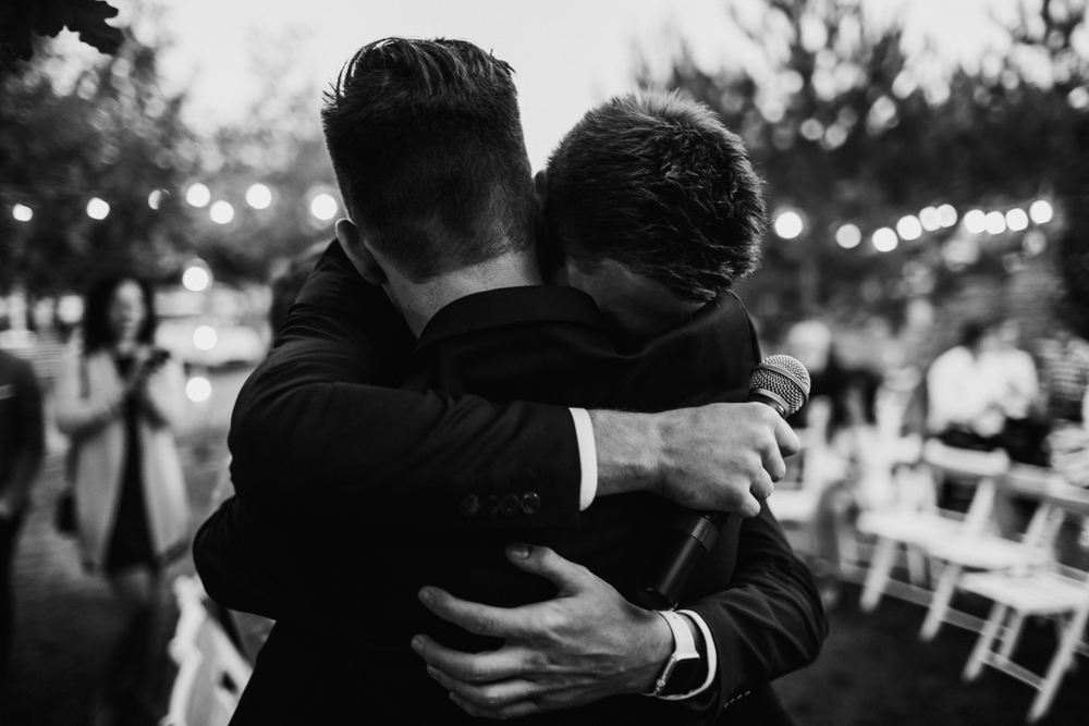 groom hugging his best man