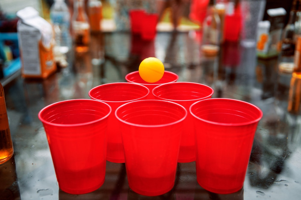 red cups ang a small yellow ball
