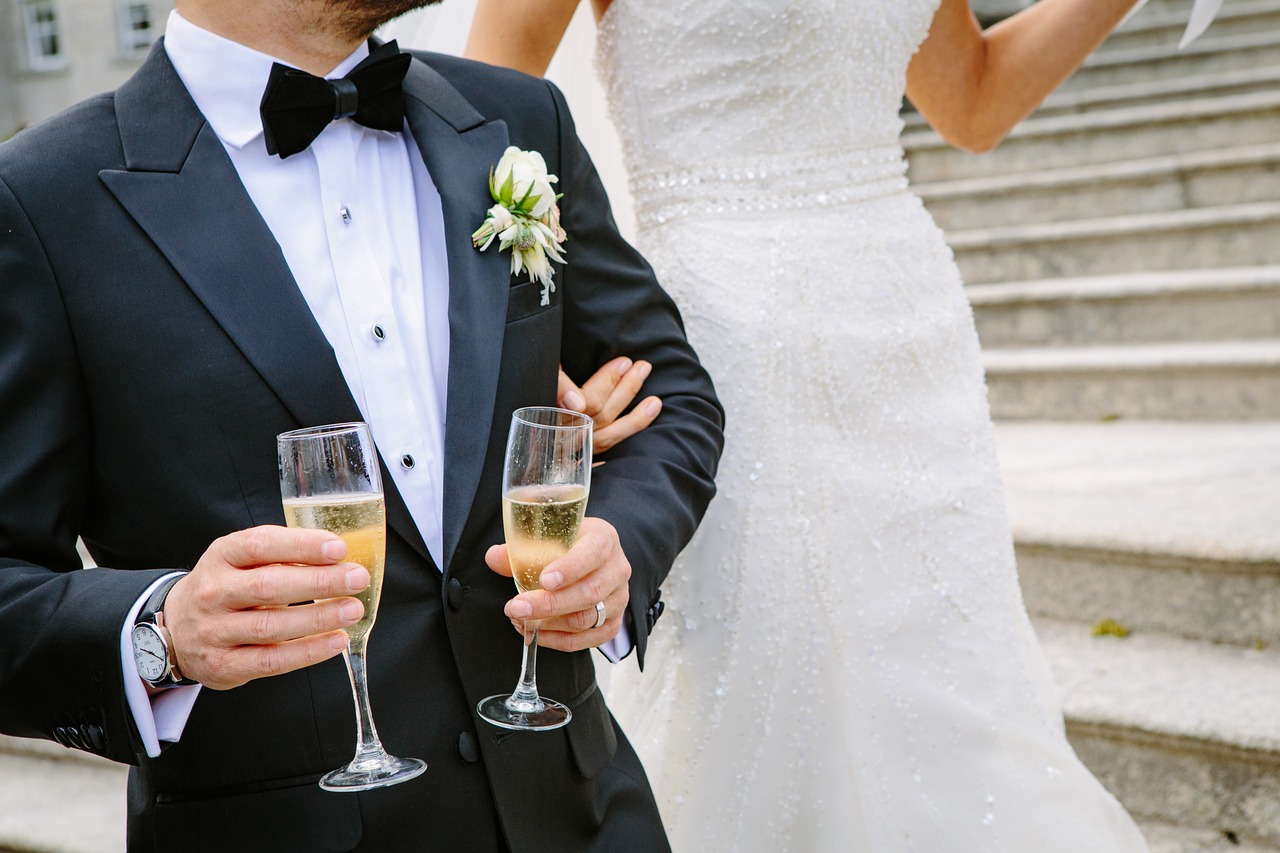 bride with the groom holding two wine glasses