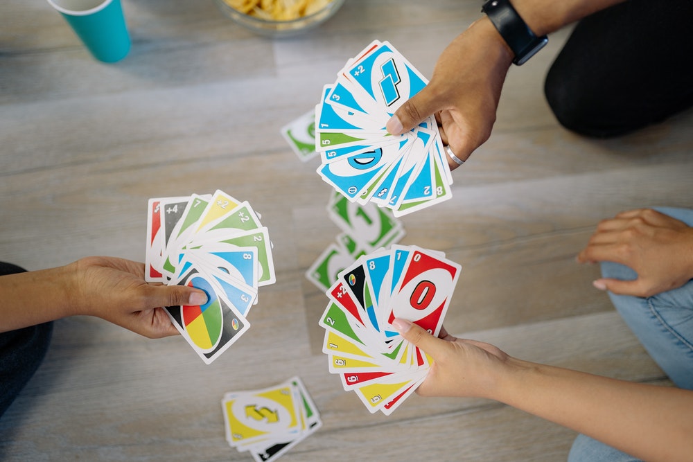 men playing uno cards