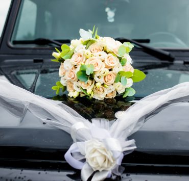 black car with a bouquet of flowers on the hood