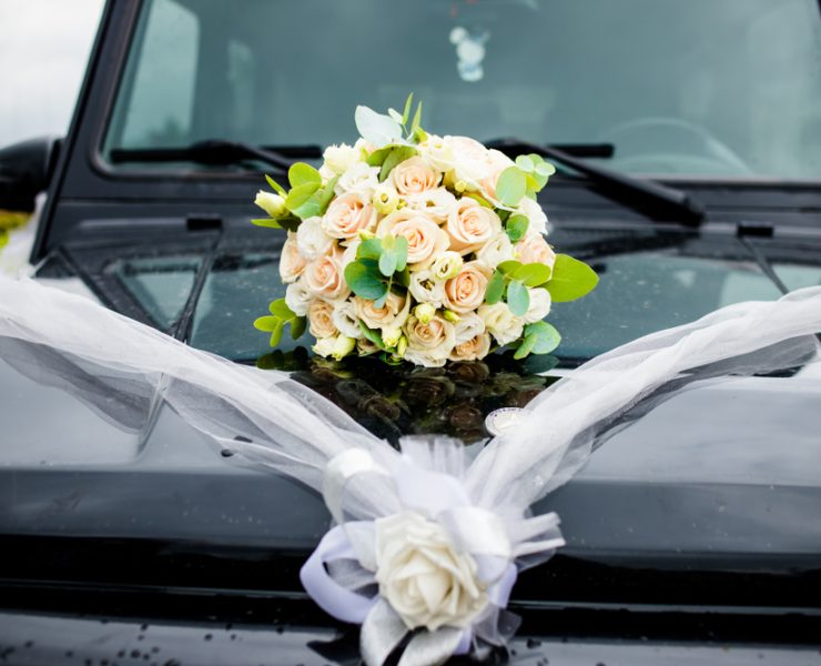 black car with a bouquet of flowers on the hood