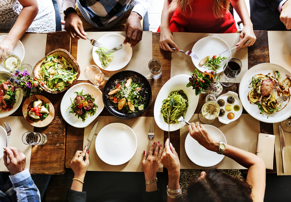 aerial view of family members and friends eating dinner