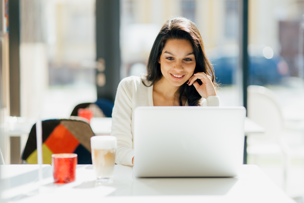 one of the bridesmaids using her laptop in engaging with the wedding posts on social media
