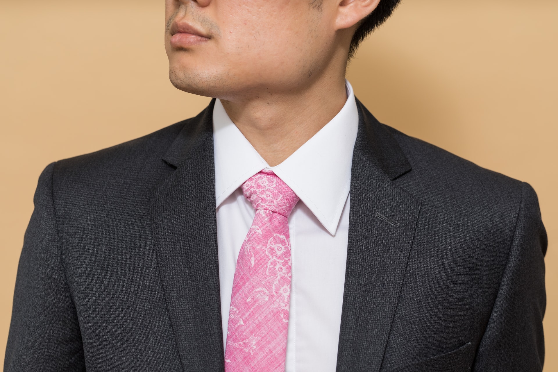 groom wearing a pink necktie with a floral pattern
