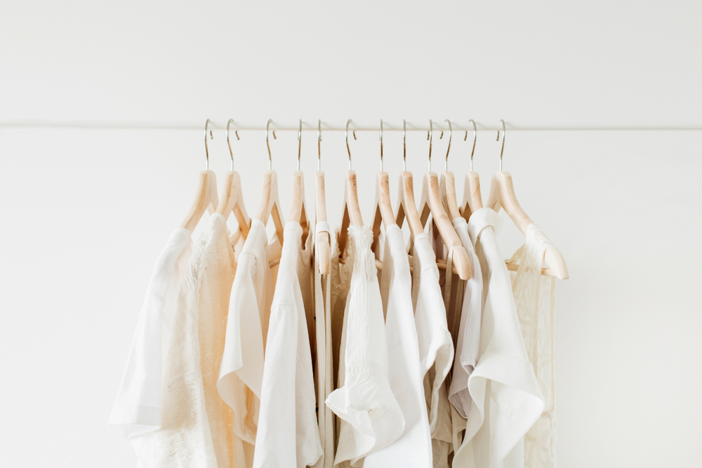 set of off white colored clothes hanged on a clothes rack