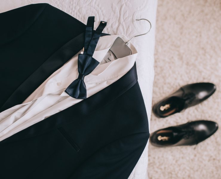 wedding suit on a bed