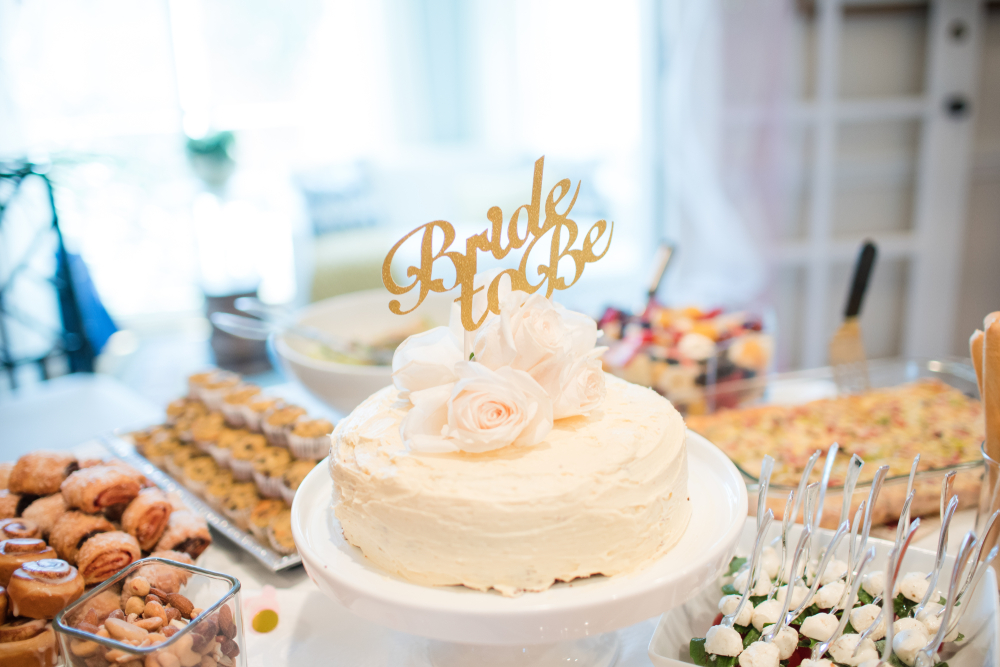 cake with bride-to-be topper and other food for the bridal shower