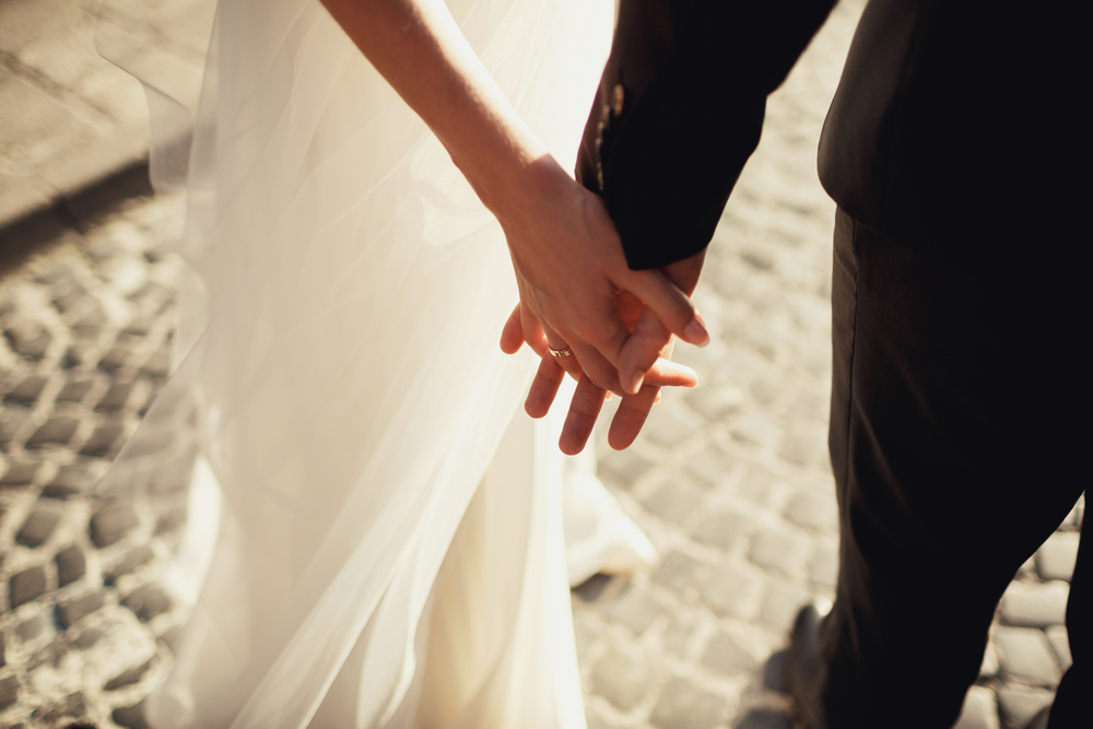 bride and groom holding hands