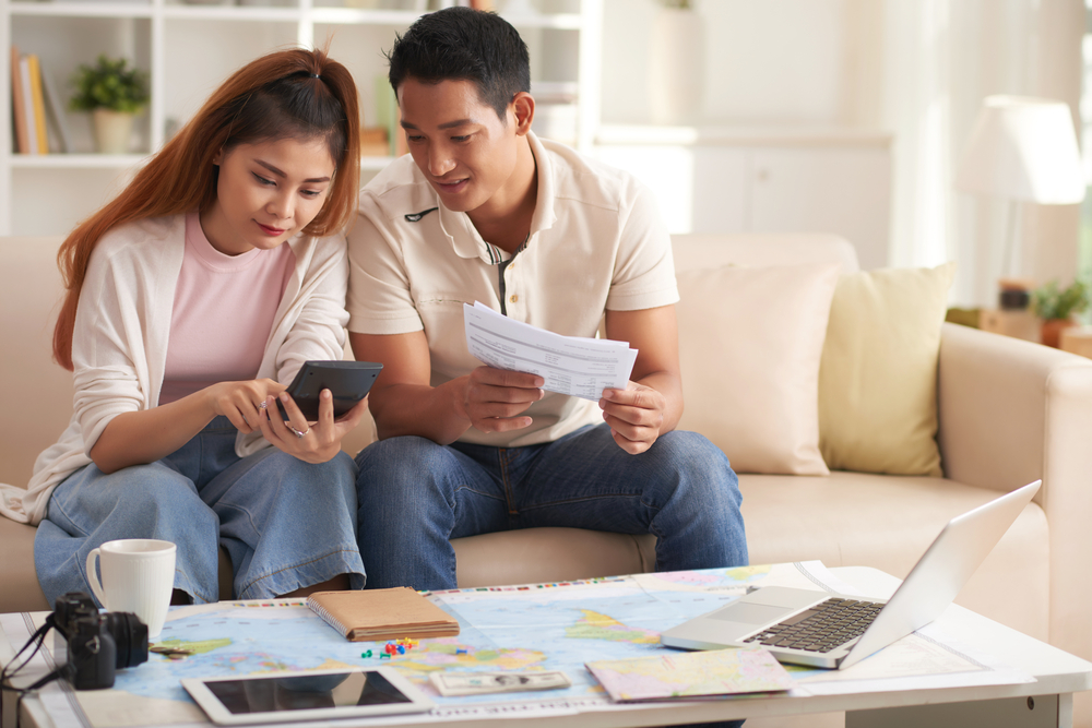 couple sitting and planning their trip together 