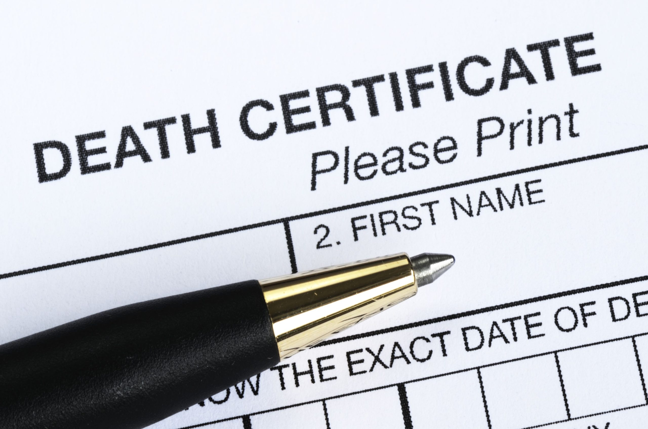 death certificate with a pen on top