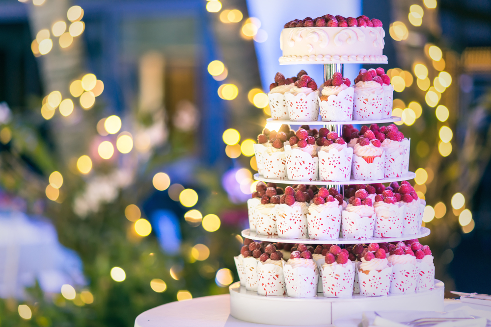 Sweet wedding cake made from fresh berry cupcake with bokeh background