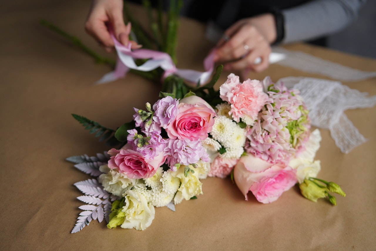 florist arranging long stemmed flowers for a wedding