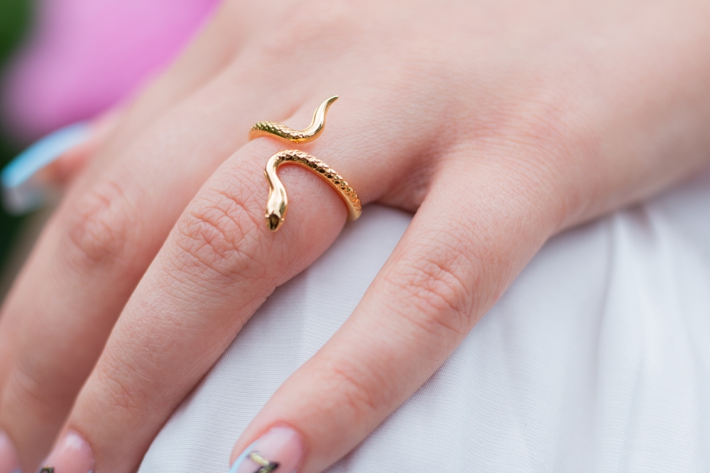 gold wrapped around snake ring on woman's finger